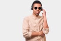 Handsome African American young man with headphones listening the favorites music. Afro male student wearing sunglasses and casual Royalty Free Stock Photo