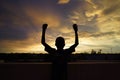Handsome African Boy Waves in front of Evening Sun