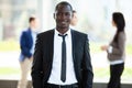 Handsome african businessman with group of businesspeople on background. Royalty Free Stock Photo