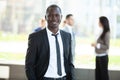 Handsome african businessman with group of businesspeople on background.