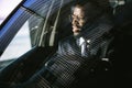 Handsome african elegant serious man drives a car Royalty Free Stock Photo