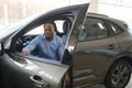 Handsome African man choosing a new car at the dealership Royalty Free Stock Photo