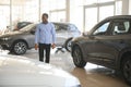 Handsome African man choosing a new car at the dealership Royalty Free Stock Photo