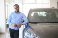 Handsome African man choosing a new car at the dealership Royalty Free Stock Photo