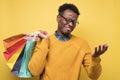 Handsome african man with shopping bags being exhausted in mall