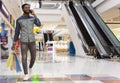 Handsome african man with shopping bags talking by cellphone Royalty Free Stock Photo
