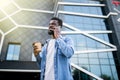 Handsome african man talking on phone at park. Young black man talking on cellphone outdoor. African american smiling guy in a Royalty Free Stock Photo
