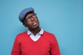 Handsome african young man in blue cao and glasses thinking looking aside Royalty Free Stock Photo