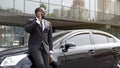 Handsome Afro-American man talking on phone with smile on face near office Royalty Free Stock Photo