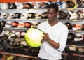 Handsome Afro man choosing biker accessories