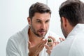 Handsome aged man applying face cream. Beauty routine. Man with perfect skin. Anti-aging and wrinkle cream. Concept of Royalty Free Stock Photo