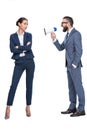 handsome aggressive businessman with megaphone screaming on his female coworker,