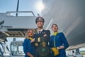 Handsome airman and smiling flight attendants looking up