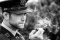 Handsome American WWII GI Army officer in uniform smoking cigar
