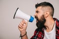 Handsome angry man yelling into megaphone, isolated Royalty Free Stock Photo