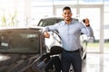 Handsome arab man customer holding key from auto, buying car