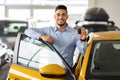 Handsome arab man customer holding key from auto and smiling