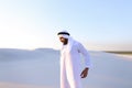 Handsome Arab sheik suffers from discomfort in back, standing in
