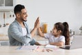 Handsome arab single father helping daughter with homework Royalty Free Stock Photo