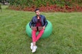 Handsome Arab Young Businessman Sits With Laptop in Chair, Looks Royalty Free Stock Photo