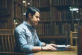 Handsome arabic guy working in old historical library. Study education abroad in europe Royalty Free Stock Photo