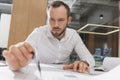 handsome architect with compass drawing building plans