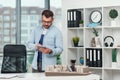 Handsome architect working on a construction project using innovation technologies. Caucasian man with tablet pc at