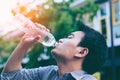 Handsome asian businessman drinking water ifrom a bottle Royalty Free Stock Photo