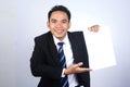 Handsome asian businessman holding a blank paper with pointing gesture