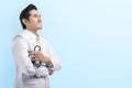 Handsome asian doctor man in white lab coat and stethoscope crossed arms Royalty Free Stock Photo