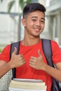 Filipino Student With Thumbs Up With Books