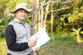 Handsome Asian man botanist is at forest to survey botanical plants