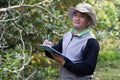 Handsome Asian man botanist is at forest to survey botanical plants