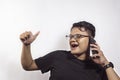 Handsome asian man calling someone using smartphone and showing agreeing expression on white background