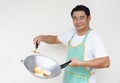 Handsome Asian man is cooking fried eggs Royalty Free Stock Photo