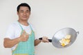 Handsome Asian man is cooking fried eggs Royalty Free Stock Photo