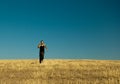 Handsome asian man running in the barley meadow in Royalty Free Stock Photo