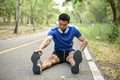 Handsome Asian man stretching his legs on the street Royalty Free Stock Photo