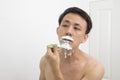 Handsome asian man trying shave beard Royalty Free Stock Photo