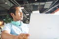 Handsome asian man using laptop looking out of window. Startup business Royalty Free Stock Photo