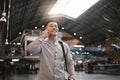 Handsome asian man using mobile in the train station. Royalty Free Stock Photo