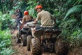 handsome asian man looking back and smiling while riding atv Royalty Free Stock Photo