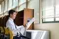 a handsome Asian student reading newspaper Royalty Free Stock Photo