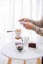 Handsome asian taking photo of chocolate cake and milk at coffee shop. Dessert or food photography hobby. Smartphone or mobile