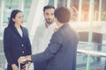 Handsome asian young businessman and businesswoman three people talking and smile Royalty Free Stock Photo