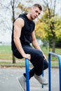 Handsome athlete resting on the bars between sets . Royalty Free Stock Photo