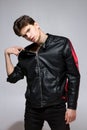 Handsome Athletic Male Model Wearing Leather Jacket on Naked Torso. Sexy young guy with a beautiful body in a biker jacket on a Royalty Free Stock Photo