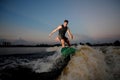 Handsome athletic man riding on wakesurf down the river during s Royalty Free Stock Photo