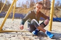 Handsome athletic man sitting on the sand field for beach soccer Royalty Free Stock Photo