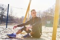 Handsome athletic man sitting on the sand field for beach soccer Royalty Free Stock Photo